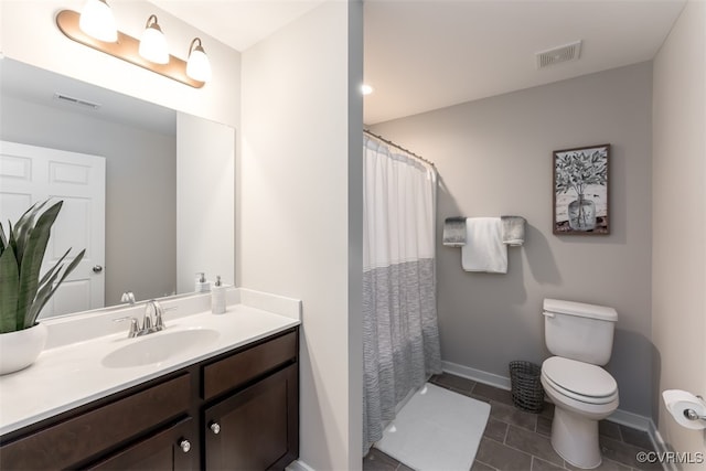 bathroom with vanity, toilet, and tile patterned floors