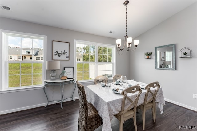 dining room with a notable chandelier, vaulted ceiling, and dark hardwood / wood-style flooring