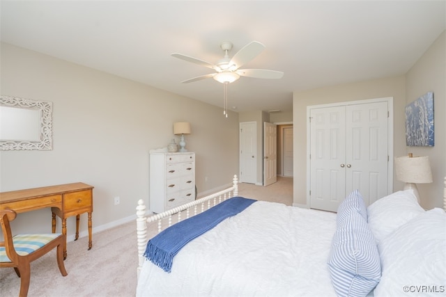 bedroom featuring ceiling fan, light colored carpet, and a closet