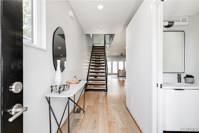 interior space with light hardwood / wood-style flooring and sink