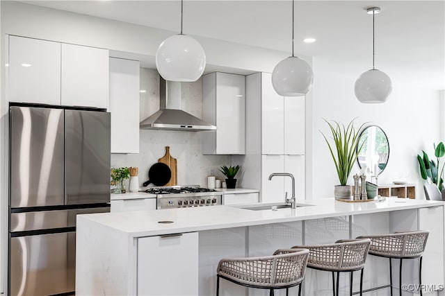 kitchen with white cabinets, a center island with sink, appliances with stainless steel finishes, and sink