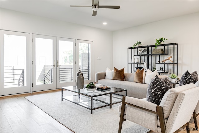 living room featuring light hardwood / wood-style flooring, ceiling fan, and french doors