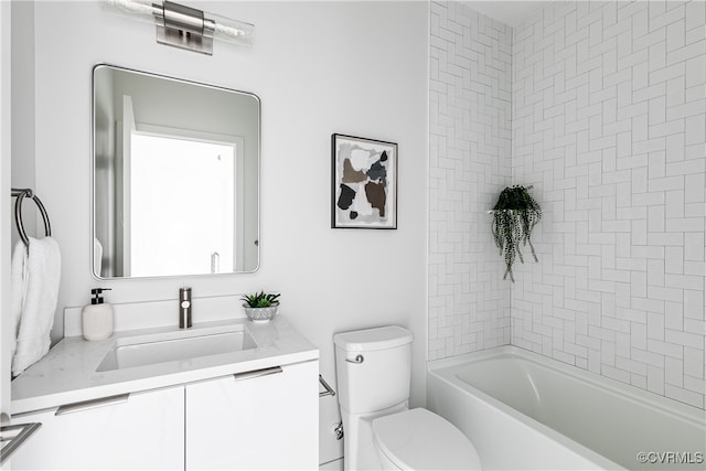 full bathroom with tiled shower / bath combo, vanity, and toilet