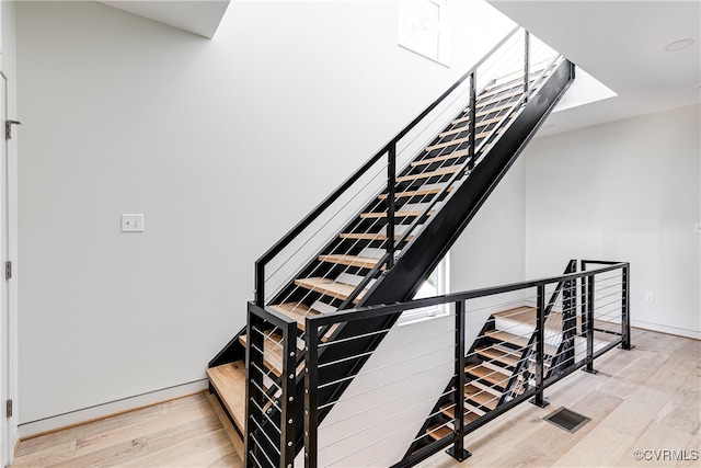 stairway featuring wood-type flooring