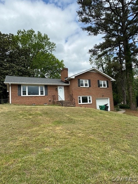 view of front of home with a front yard and a garage