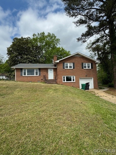 split level home featuring a garage and a front yard