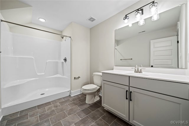 bathroom with a shower, vanity, and toilet