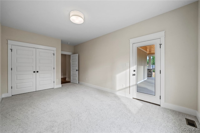 unfurnished bedroom with a closet and carpet