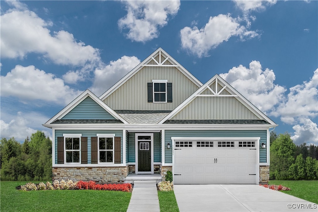 craftsman inspired home with a garage and a front lawn