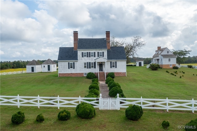 colonial-style house with a front lawn