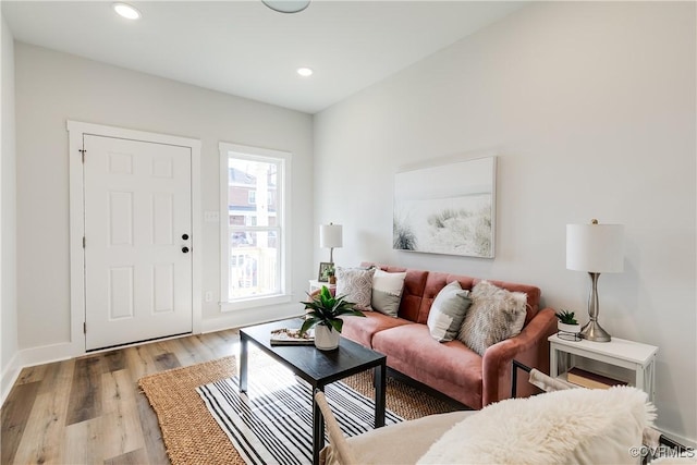 living room featuring recessed lighting, light wood-style flooring, and baseboards