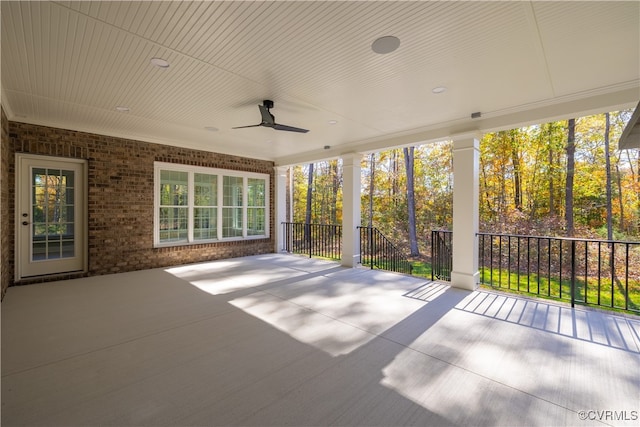 unfurnished sunroom featuring ceiling fan