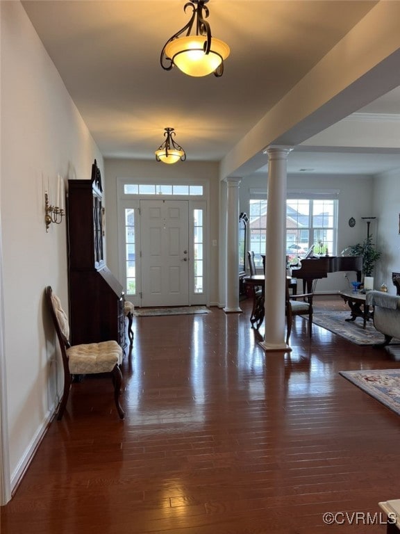 foyer with decorative columns and dark hardwood / wood-style flooring