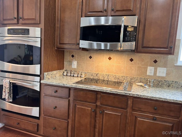 8232 E Lord Botetourt Loop, New Kent, VA 23124 - kitchen with tasteful backsplash, stainless steel appliances, and light stone countertops