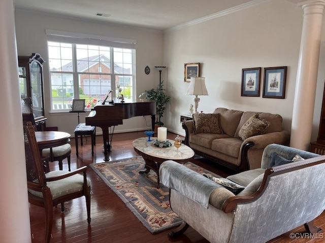 living room featuring decorative columns, dark hardwood / wood-style floors, and crown molding