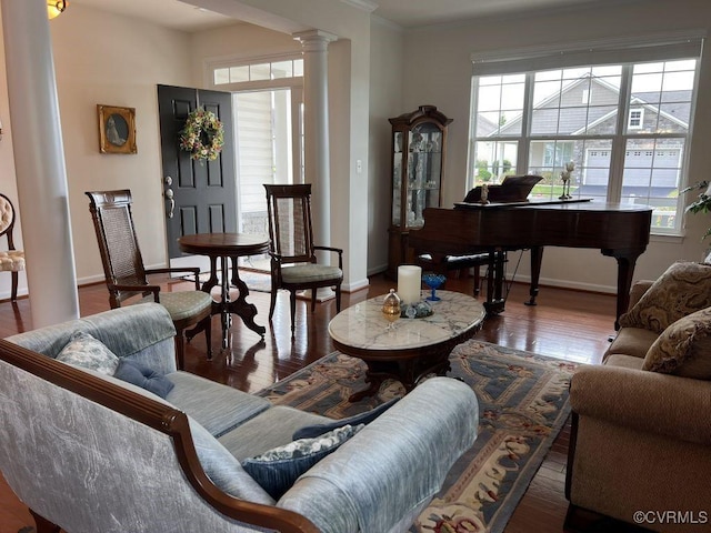 8232 E Lord Botetourt Loop, New Kent, VA 23124 - living area with ornate columns, wood finished floors, crown molding, and baseboards