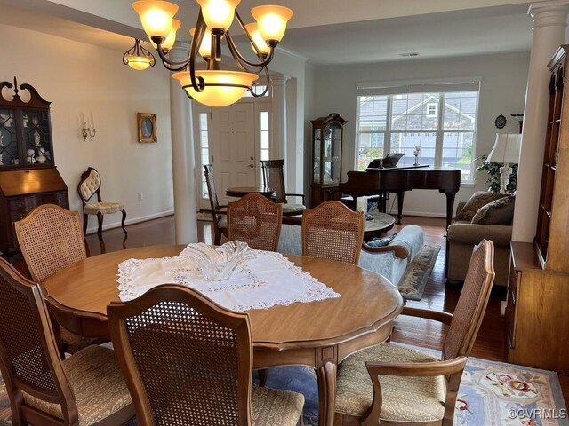 8232 E Lord Botetourt Loop, New Kent, VA 23124 - dining area with ornamental molding, an inviting chandelier, wood finished floors, and baseboards