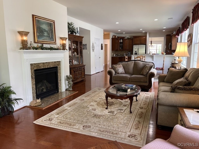 living room with dark hardwood / wood-style floors and a high end fireplace