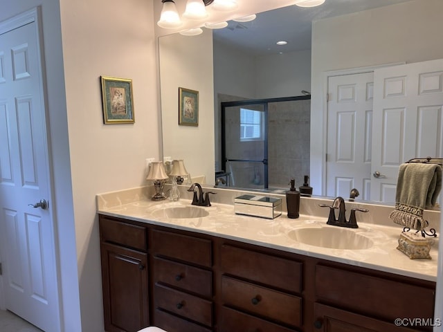 bathroom with an enclosed shower and vanity