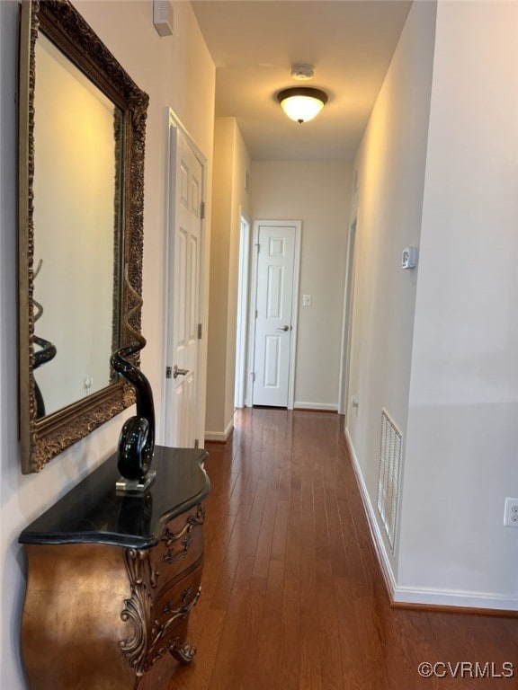 hallway with dark hardwood / wood-style floors