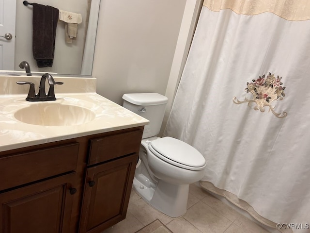 bathroom with vanity, toilet, and tile patterned floors