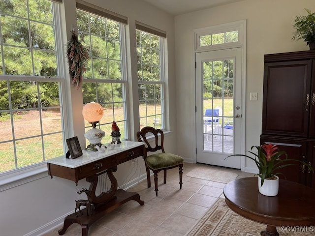 doorway to outside with plenty of natural light and light tile patterned floors