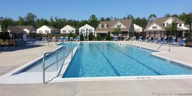 8232 E Lord Botetourt Loop, New Kent, VA 23124 - community pool with a residential view, a patio, and fence