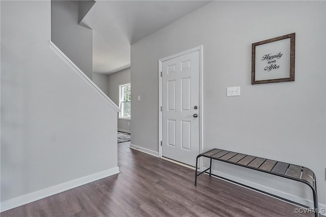 foyer with baseboards and dark wood finished floors