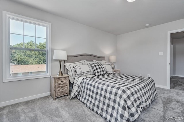 bedroom with light carpet and baseboards