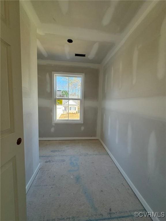 unfurnished room featuring baseboards