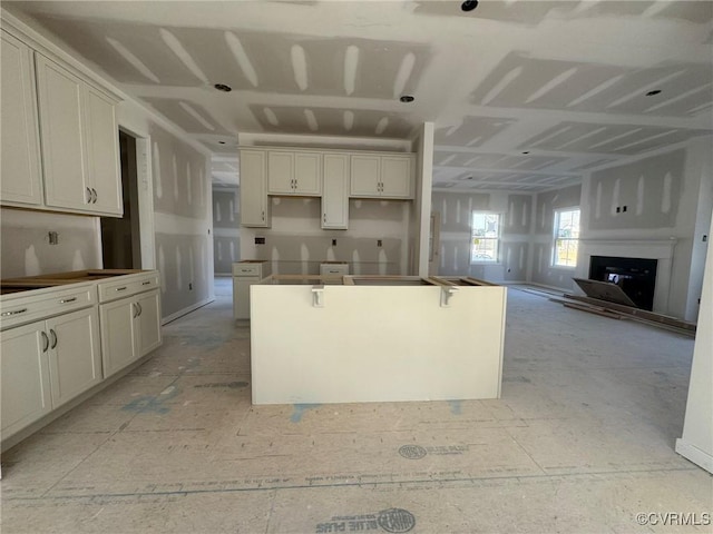 kitchen featuring a center island and a fireplace with raised hearth