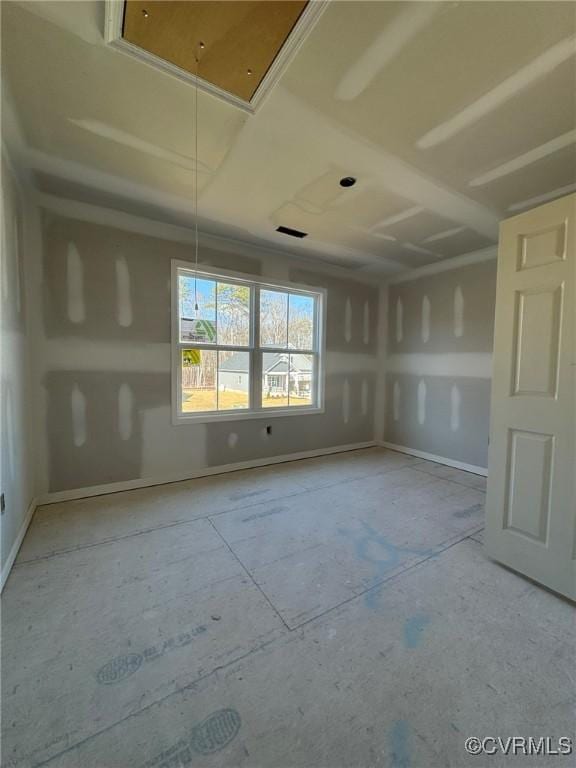 empty room featuring visible vents and attic access