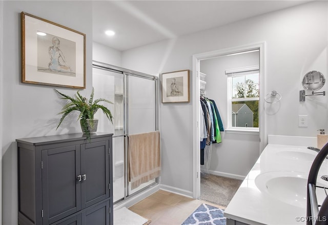 bathroom with walk in shower and vanity