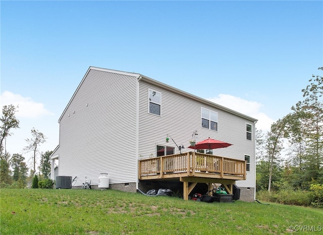 back of house with a deck, a yard, and central AC