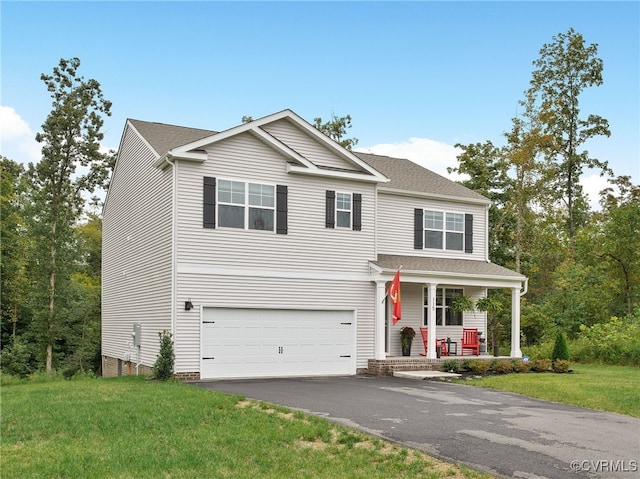 view of front of property featuring covered porch, a front yard, and a garage