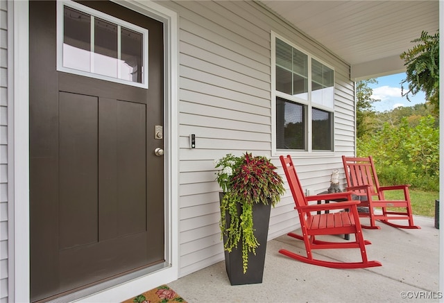 view of exterior entry with a porch