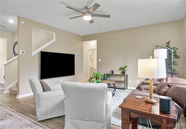 living room with ceiling fan and light hardwood / wood-style floors