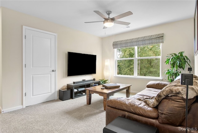 carpeted living room with ceiling fan