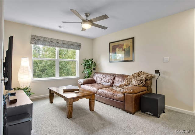 carpeted living room with ceiling fan