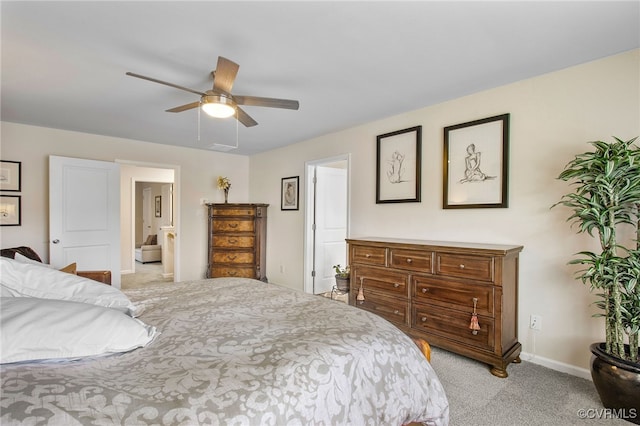 carpeted bedroom featuring ensuite bath and ceiling fan