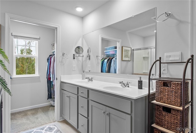 bathroom with vanity and a shower with shower door