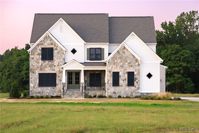 view of front facade with a yard and covered porch