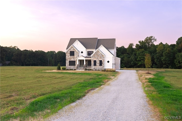 view of front of house featuring a lawn and a garage