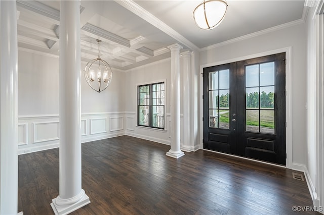 foyer entrance featuring crown molding, dark hardwood / wood-style flooring, and ornate columns