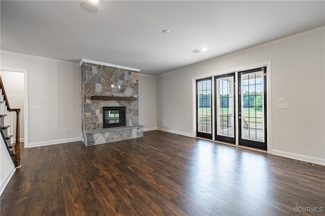 unfurnished living room with a stone fireplace, crown molding, and dark wood-type flooring