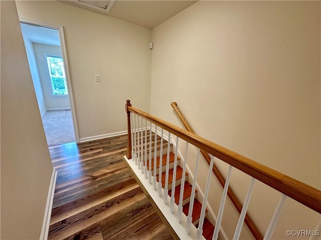 stairs featuring hardwood / wood-style floors