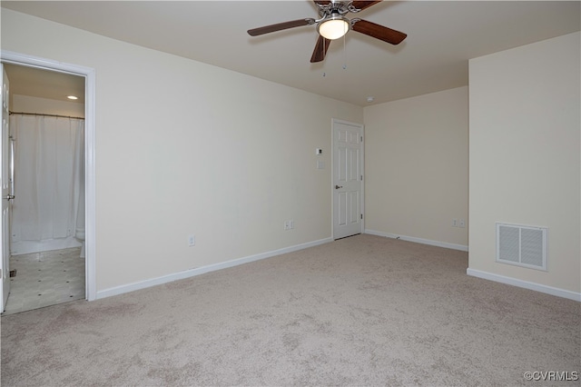 carpeted empty room featuring ceiling fan