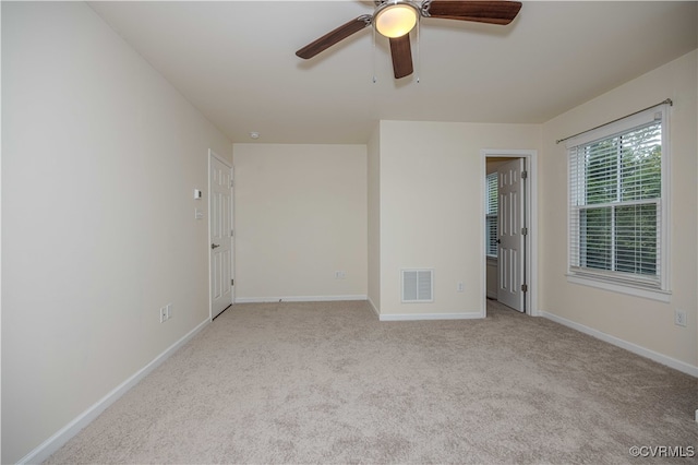 spare room featuring ceiling fan and light carpet