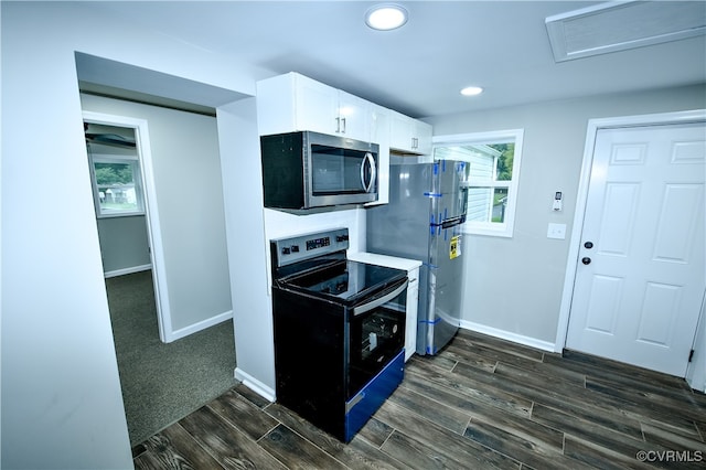 kitchen featuring stainless steel appliances, white cabinets, and dark wood-type flooring