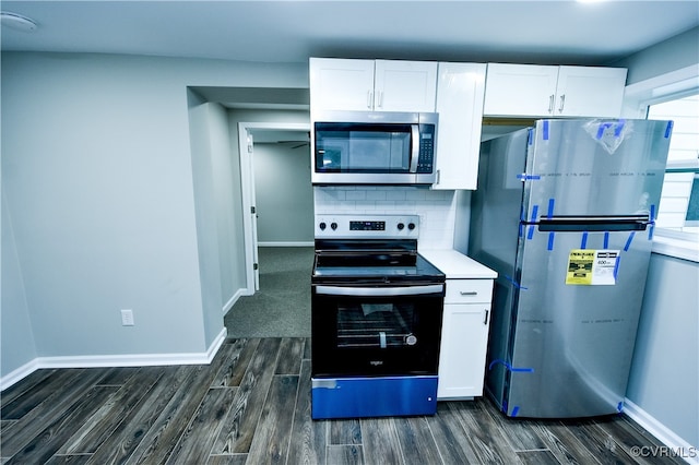 kitchen featuring white cabinets, appliances with stainless steel finishes, and dark hardwood / wood-style flooring